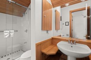 a white bathroom with a sink and a toilet at Independence Square 311, Best Location! Hotel Room with Rooftop Hot Tub in Aspen in Aspen