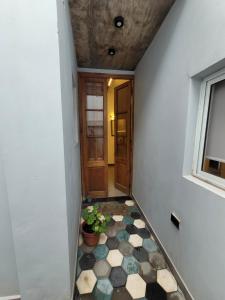 a hallway with a tiled floor and a door at 9 de julio in San Miguel de Tucumán