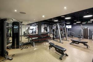 a gym with a bunch of equipment in a room at DoubleTree By Hilton Brighton Metropole in Brighton & Hove