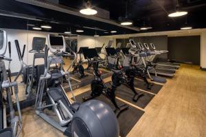 a gym with rows of exercise bikes and treadmills at DoubleTree By Hilton Brighton Metropole in Brighton & Hove