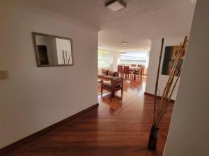 - un salon avec une table, une chaise et un miroir dans l'établissement Lujoso apartamento en Bellavista, à Quito