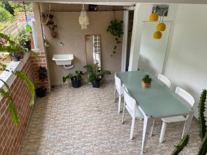 a table and chairs in a patio with plants at Casa Zona Sul in Rio de Janeiro