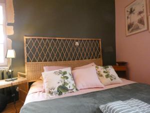 Schlafzimmer mit einem Bett mit rosa und weißen Kissen in der Unterkunft Chambre calme Ouest Lyonnais in Lentilly