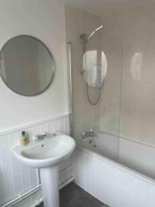 a bathroom with a sink and a mirror and a shower at Stylish Property in Nuneaton in Nuneaton