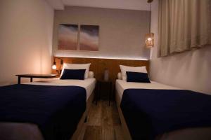 Leblon Design Hotel客房内的一张或多张床位