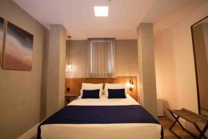 Leblon Design Hotel客房内的一张或多张床位