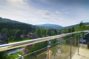 a balcony with a view of the mountains at Tęczowe Wzgórze in Wisła