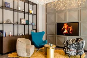 ein Wohnzimmer mit zwei Stühlen und einem Kamin in der Unterkunft Motel One Ulm in Ulm