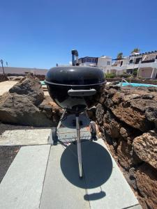 a grill sitting on a stand on a sidewalk at Bungalow Rey Carlos in Puerto del Carmen