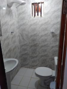 a bathroom with a toilet and a sink at Vi&Li Suites in Aracaju