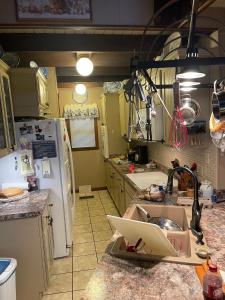 a kitchen with a sink and a refrigerator at Smokey Mountain Cabin in Murphy