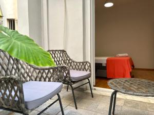 two chairs and a table on a balcony at P&P - Brand new chic apartments in Athens