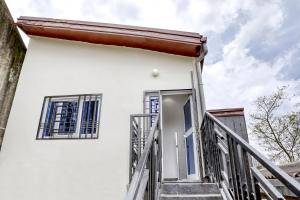 a stairway leading up to a white house at Cosy Home in Douala