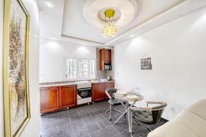 a kitchen with a table and chairs in a room at Cosy Home in Douala