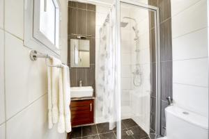 a bathroom with a shower and a sink at Cosy Home in Douala