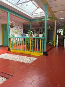 a house with a colorful fence and plants in it at LA ESTIBA HOTEL in Salento