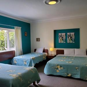 a hotel room with two beds and a window at The Place Miraflores in Lima