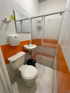 a bathroom with a toilet and a sink at HOTEL LIGHT PLAZA in Aguachica