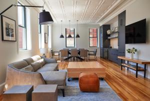 a living room with a couch and a table at The Docent's Collection in Portland