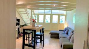 a living room with a table and a blue couch at Paradis Mimies Dominican Bay in Boca Chica