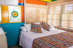 - une chambre avec un lit et des oreillers dans l'établissement La Querendona Alojamiento Cafetero, à Pereira