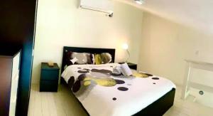 a bedroom with a bed with a cow print on it at Paradis Mimies Dominican Bay in Boca Chica