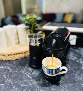 a coffee maker with a cup of coffee on a counter at Ocean Breeze Family Getaway - Short drive to Beach & Adventure Park in Ocean Grove