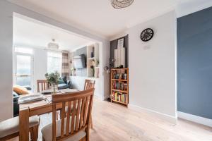 a dining room and living room with a table and chairs at SuffStay in Ipswich