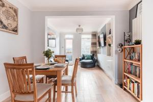 a dining room and living room with a table and chairs at SuffStay in Ipswich