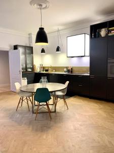 a kitchen with a table and two chairs and a table at Christianshavn Canalside Luxury Apartment in Copenhagen