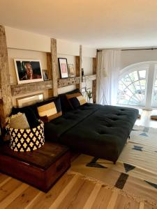 a bedroom with a large bed and a couch at Christianshavn Canalside Luxury Apartment in Copenhagen