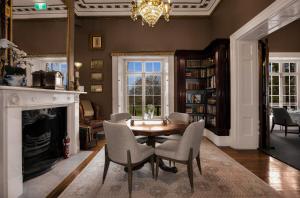 a dining room with a table and chairs and a chandelier at Quamby Estate in Hagley