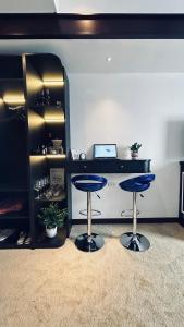 a room with two blue stools in front of a counter at Mango Hotel - Ha Noi Railway station in Hanoi