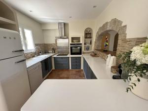 a kitchen with a sink and a refrigerator at Villa de Luxe 4 Chambres avec Piscine Chauffée et Aménagements Haut de Gamme, La Croix-Valmer - FR-1-726-32 in La Croix-Valmer