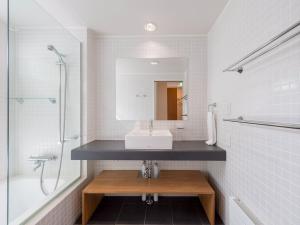 a bathroom with a sink and a shower and a mirror at Ｂａｗ Ｂａｗ Ｓａｎｓｏｕ - Vacation STAY 27989v in Niseko