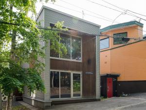 a house with glass windows on the side of it at Ｂａｗ Ｂａｗ Ｓａｎｓｏｕ - Vacation STAY 27989v in Niseko