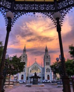 a large white church with a statue in front of it at Room #3 in Aguada +5 photos