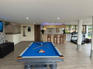 a pool table in the middle of a living room at Finca La Perla in Armenia
