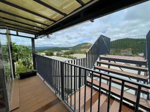 a balcony with stairs and a view of the ocean at Da Quy Harmony Homestay in Da Lat