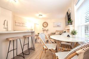 una cucina e un soggiorno con tavolo e sedie di Gorgeous 2 Bedroom Cottage by the City a Victoria