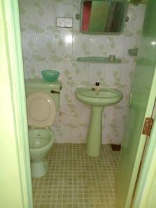a bathroom with a toilet and a sink at Pradeepa house in Unawatuna