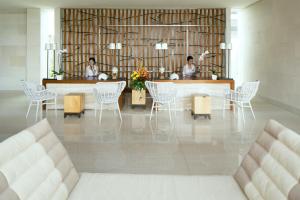 Dos mujeres sentadas en una mesa en una habitación en Samabe Bali Suites & Villas, en Nusa Dua