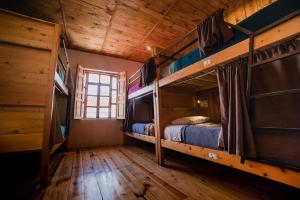 a bedroom with two bunk beds in a cabin at Puerta Vieja Hostel in San Cristóbal de Las Casas