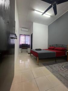 a large room with a bed and a window at AZ MUSLIM HOMESTAY in Seremban