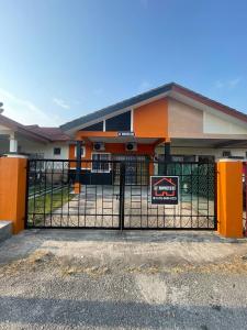a building with a gate with a sign on it at AZ MUSLIM HOMESTAY in Seremban