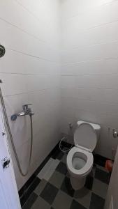 a small bathroom with a toilet and a shower at Jasmin Homestay in Sanur +9 photos