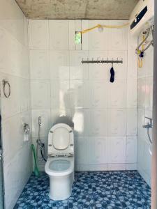 a bathroom with a toilet and a blue and white tile floor at Triệu Chương Homestay in Cao Bằng