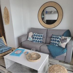 a living room with a couch and a table at Magnificent Mediterranean Views in Cabo de Palos