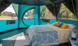 A bed or beds in a room at Camp Agastya Karjat Bhimashankar