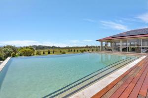a swimming pool in front of a house at Noble Willow Estate in Lovedale